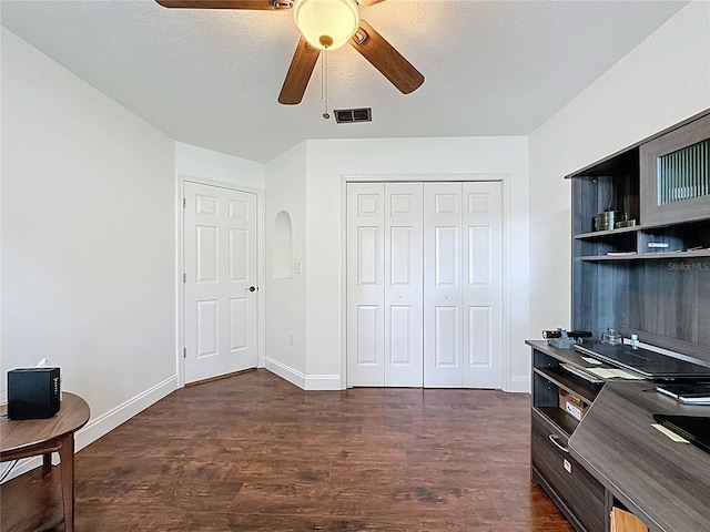 238 Sunridge Woods Blvd, Davenport, FL 33837 - office area with dark wood-style floors, ceiling fan, and arched walkways