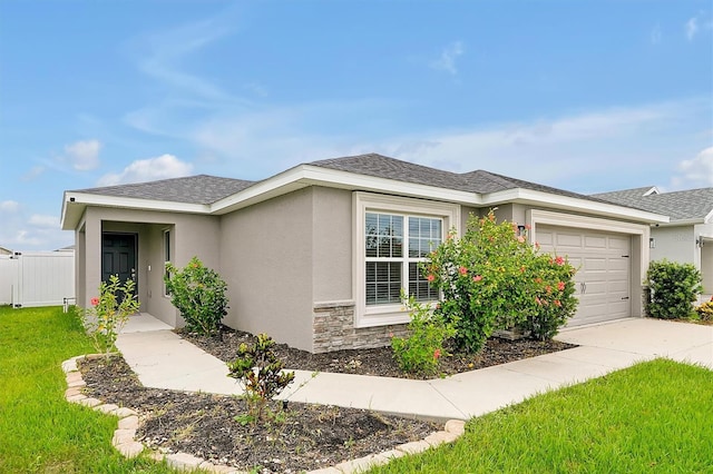 4505 Hummingbird Ln, Haines City, FL 33844 - view of front of house featuring a garage, driveway, stucco siding, and stone siding