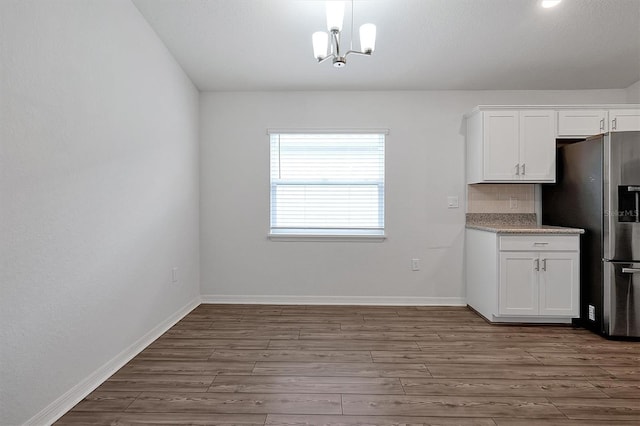 4505 Hummingbird Ln, Haines City, FL 33844 - unfurnished dining area with a chandelier and dark wood finished floors