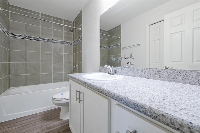 4505 Hummingbird Ln, Haines City, FL 33844 - full bathroom with vanity, wood finished floors, and shower / tub combination