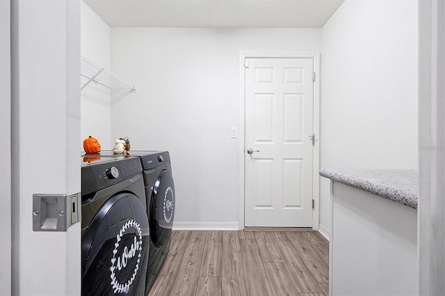 4505 Hummingbird Ln, Haines City, FL 33844 - laundry area with separate washer and dryer and light wood-style flooring