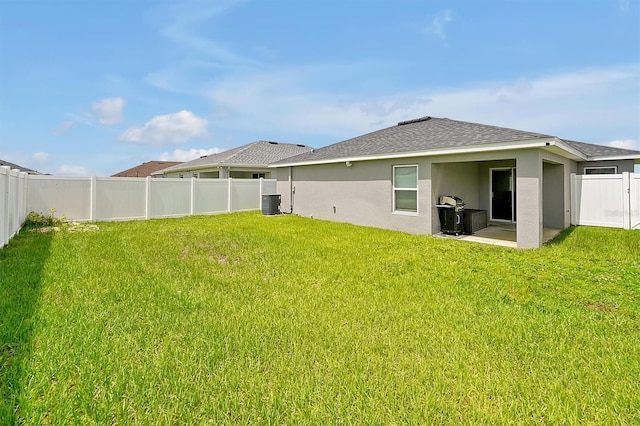 4505 Hummingbird Ln, Haines City, FL 33844 - back of house featuring stucco siding, a fenced backyard, a patio, and roof with shingles