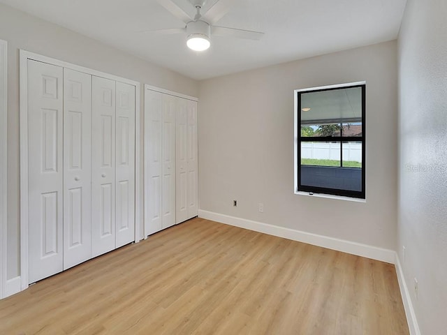 925 Roswell Ter, Deltona, FL 32738 - unfurnished bedroom with multiple closets, light wood finished floors, and a ceiling fan
