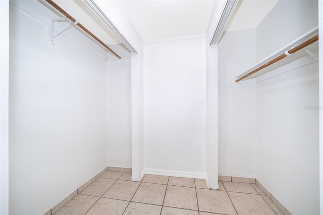 12104 Shallot St, Orlando, FL 32837 - spacious closet with light marble finish flooring