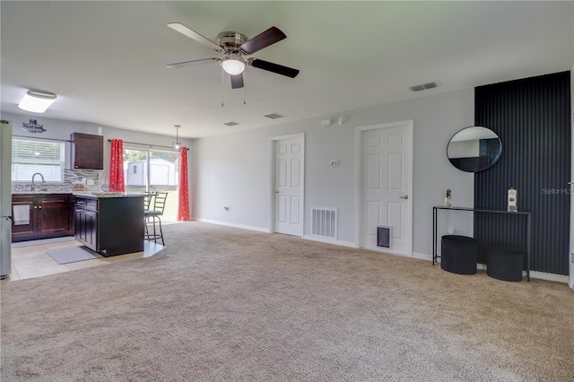 10 Pine Track Trl, Ocala, FL 34472 - unfurnished living room featuring ceiling fan and light carpet