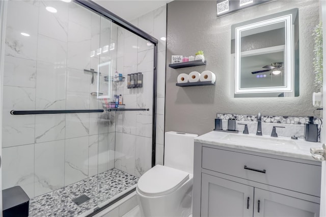 10 Pine Track Trl, Ocala, FL 34472 - bathroom featuring a textured wall, a stall shower, vanity, and a ceiling fan