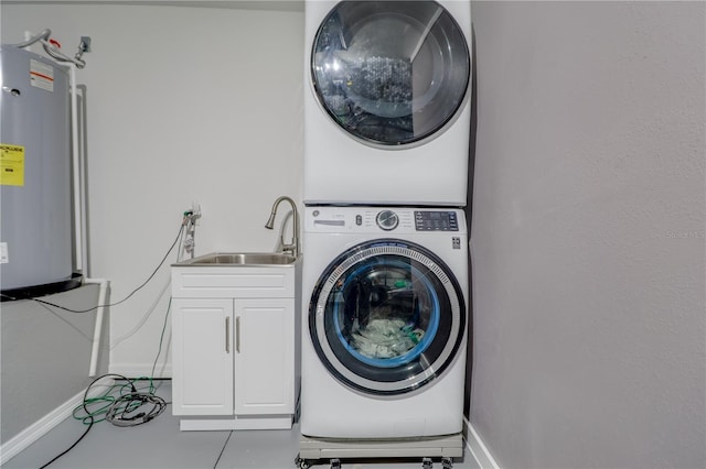 10 Pine Track Trl, Ocala, FL 34472 - laundry area with water heater, stacked washing machine and dryer, and cabinet space