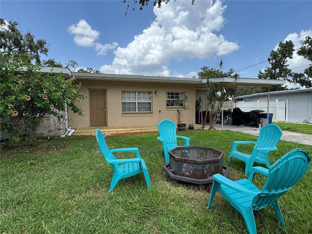 760 Bearcreek Dr, Bartow, FL 33830 - rear view of house featuring an outdoor fire pit, brick siding, and a patio area