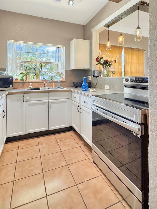 760 Bearcreek Dr, Bartow, FL 33830 - kitchen with appliances with stainless steel finishes, white cabinetry, light countertops, and backsplash