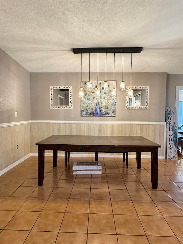 760 Bearcreek Dr, Bartow, FL 33830 - playroom with a textured ceiling, a wainscoted wall, and tile patterned floors