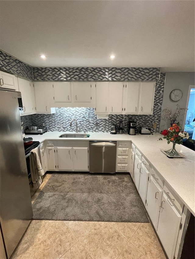 2013 Marilyn Ave, Winter Haven, FL 33881 - kitchen featuring stainless steel appliances, white cabinetry, backsplash, light countertops, and recessed lighting