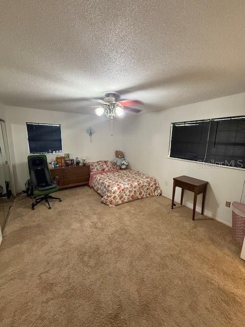 2013 Marilyn Ave, Winter Haven, FL 33881 - bedroom with carpet, a textured ceiling, and ceiling fan