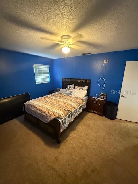 2013 Marilyn Ave, Winter Haven, FL 33881 - carpeted bedroom featuring a textured ceiling and ceiling fan