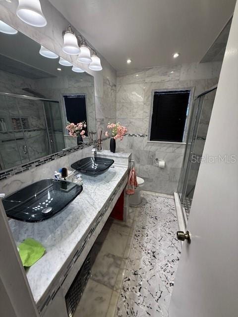 2013 Marilyn Ave, Winter Haven, FL 33881 - bathroom with double vanity, marble finish flooring, a stall shower, and recessed lighting