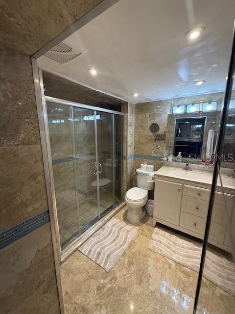 2013 Marilyn Ave, Winter Haven, FL 33881 - full bath with vanity, tile walls, a shower stall, recessed lighting, and marble finish floors