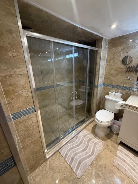 2013 Marilyn Ave, Winter Haven, FL 33881 - bathroom featuring vanity, tile walls, and a stall shower