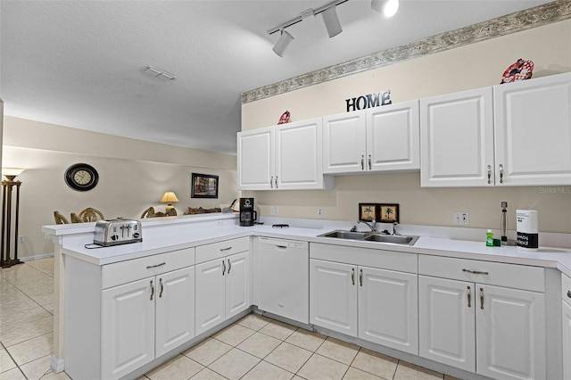 3111 Sun Lake Ct Unit B, Kissimmee, FL 34747 - kitchen with white dishwasher, a peninsula, light tile patterned floors, light countertops, and track lighting