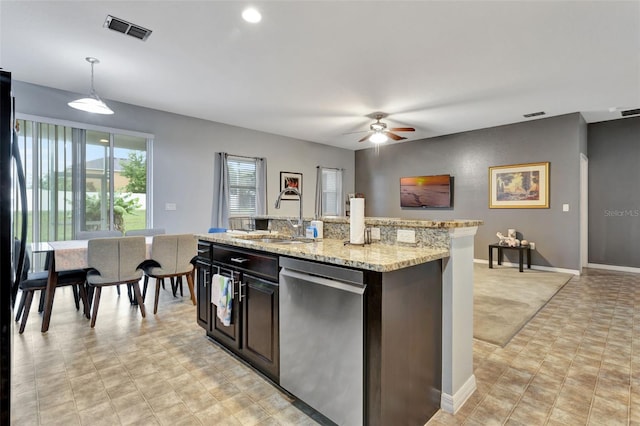 954 Revere Ave, Haines City, FL 33844 - kitchen featuring dishwasher, a ceiling fan, pendant lighting, light stone counters, and dark brown cabinetry