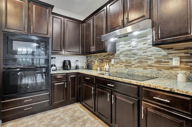 954 Revere Ave, Haines City, FL 33844 - kitchen featuring black appliances, under cabinet range hood, tasteful backsplash, light stone countertops, and dark brown cabinetry