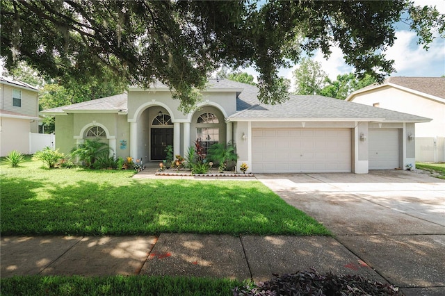 4428 Winding River Dr, Valrico, FL 33596 - view of front of house with an attached garage, concrete driveway, stucco siding, and a shingled roof