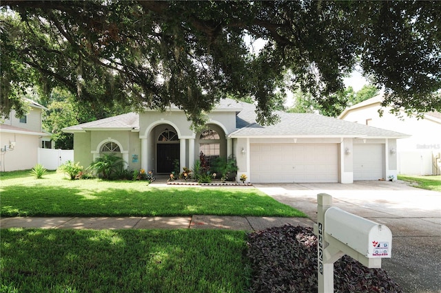 4428 Winding River Dr, Valrico, FL 33596 - view of front facade featuring a garage, concrete driveway, stucco siding, and roof with shingles