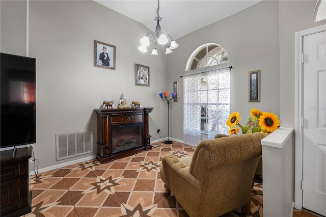 4428 Winding River Dr, Valrico, FL 33596 - living area with a chandelier, vaulted ceiling, and a glass covered fireplace