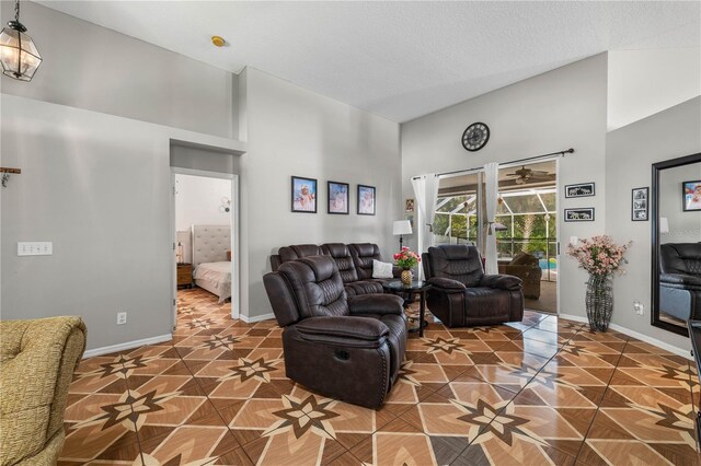 4428 Winding River Dr, Valrico, FL 33596 - tiled living area with a towering ceiling and baseboards