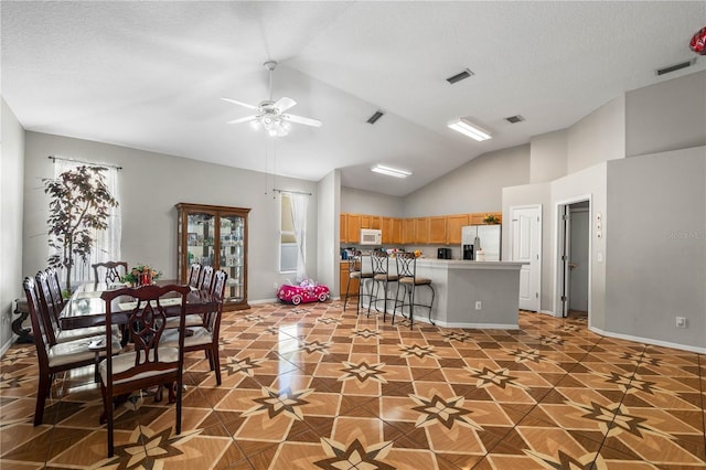 4428 Winding River Dr, Valrico, FL 33596 - kitchen featuring fridge with ice dispenser, white microwave, lofted ceiling, a ceiling fan, and light brown cabinetry
