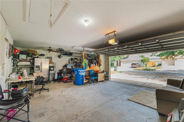 4428 Winding River Dr, Valrico, FL 33596 - garage featuring stainless steel refrigerator with ice dispenser and a garage door opener