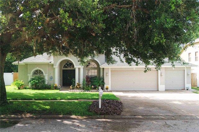4428 Winding River Dr, Valrico, FL 33596 - obstructed view of property with stucco siding, an attached garage, concrete driveway, and roof with shingles