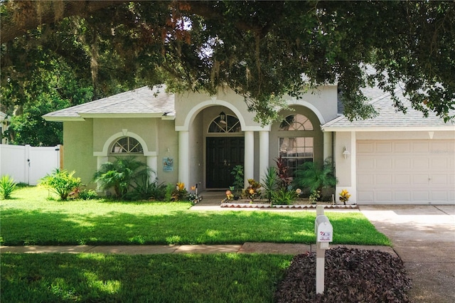 4428 Winding River Dr, Valrico, FL 33596 - view of front of house with a garage, driveway, stucco siding, and a shingled roof