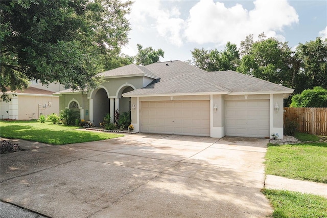 4428 Winding River Dr, Valrico, FL 33596 - view of front facade with stucco siding, a garage, driveway, and a shingled roof