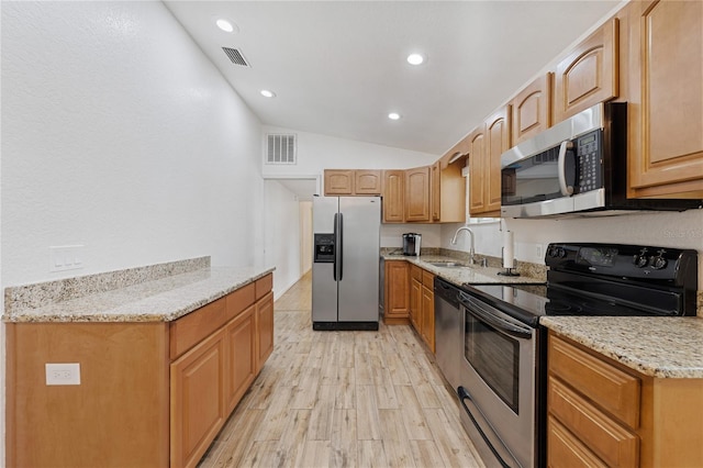 2343 St George Dr, Davenport, FL 33837 - kitchen featuring stainless steel appliances, lofted ceiling, light stone counters, light wood finished floors, and recessed lighting