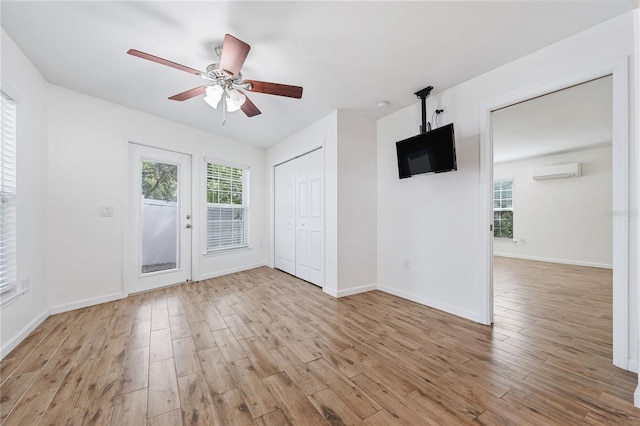 2343 St George Dr, Davenport, FL 33837 - empty room with a ceiling fan, a wall mounted AC, wood finished floors, and a smoke detector