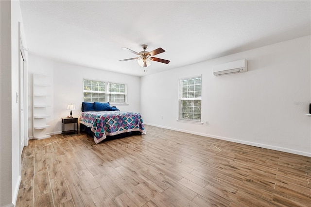2343 St George Dr, Davenport, FL 33837 - bedroom with a wall unit AC, wood finished floors, and ceiling fan