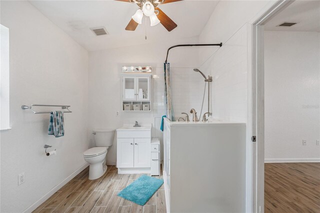 2343 St George Dr, Davenport, FL 33837 - full bath featuring ceiling fan, wood finished floors, vanity, and a stall shower