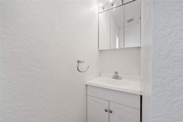 2343 St George Dr, Davenport, FL 33837 - bathroom featuring a textured wall and vanity