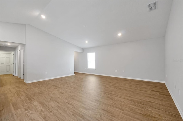 328 Lily Ln, Davenport, FL 33837 - spare room with vaulted ceiling, light wood-style floors, and recessed lighting