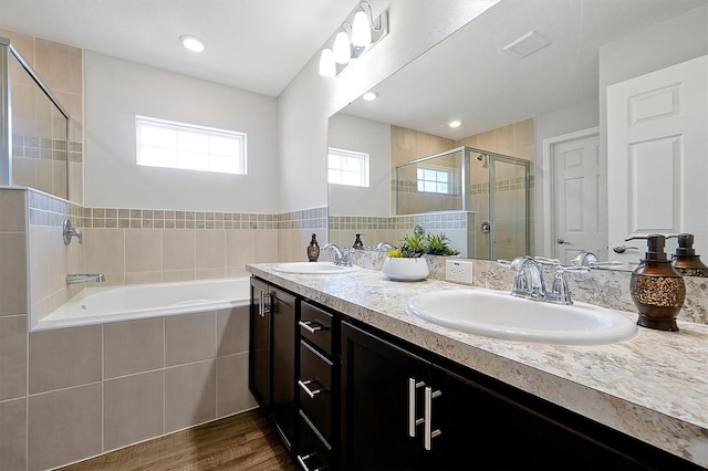 328 Lily Ln, Davenport, FL 33837 - full bath with a stall shower, a garden tub, double vanity, and wood finished floors