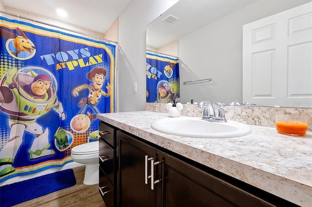 328 Lily Ln, Davenport, FL 33837 - bathroom featuring vanity, wood finished floors, and curtained shower