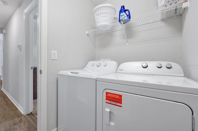 328 Lily Ln, Davenport, FL 33837 - laundry area featuring wood finished floors and washing machine and dryer