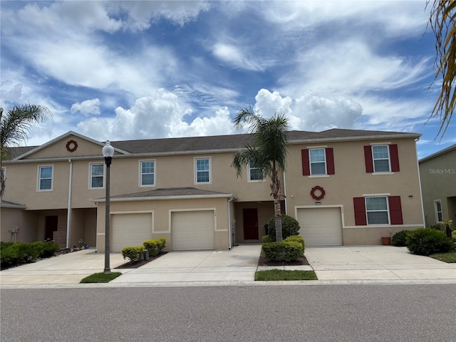 359 Arbor Lakes Dr, Davenport, FL 33896 - view of property featuring stucco siding, driveway, and an attached garage