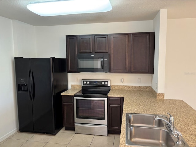 359 Arbor Lakes Dr, Davenport, FL 33896 - kitchen with black appliances, dark brown cabinetry, light countertops, and light tile patterned flooring