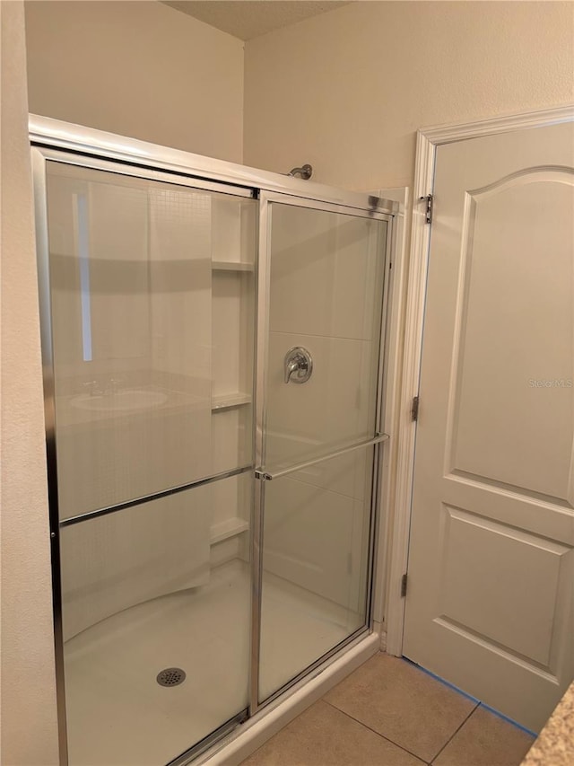 359 Arbor Lakes Dr, Davenport, FL 33896 - bathroom featuring tile patterned floors and a shower stall