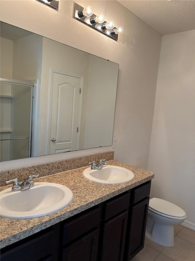 359 Arbor Lakes Dr, Davenport, FL 33896 - full bath with double vanity, a textured ceiling, a stall shower, and tile patterned floors