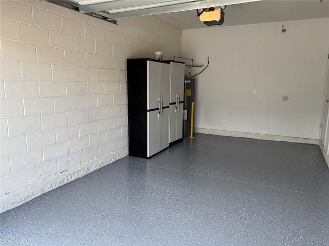 359 Arbor Lakes Dr, Davenport, FL 33896 - garage featuring a garage door opener, concrete block wall, and electric water heater