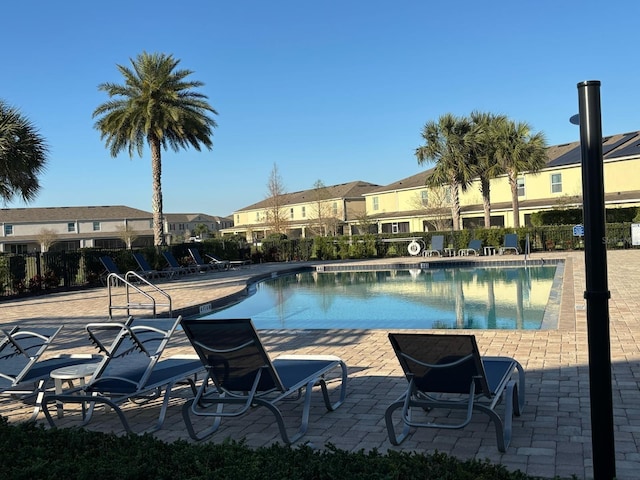 359 Arbor Lakes Dr, Davenport, FL 33896 - community pool with a residential view and a patio area
