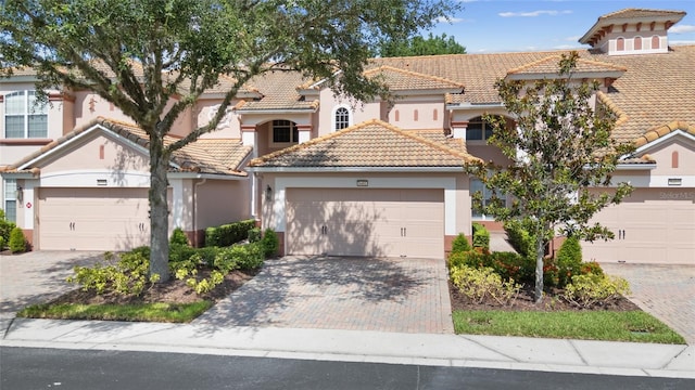 8401 Riverdale Ln Unit 8401, Davenport, FL 33896 - mediterranean / spanish house featuring a tile roof, stucco siding, driveway, and a garage