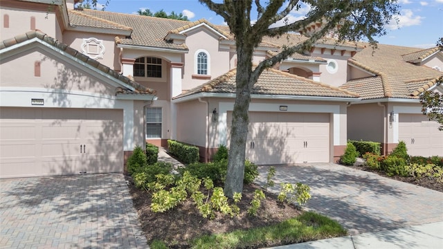 8401 Riverdale Ln Unit 8401, Davenport, FL 33896 - mediterranean / spanish-style home featuring a tiled roof, stucco siding, a garage, and decorative driveway