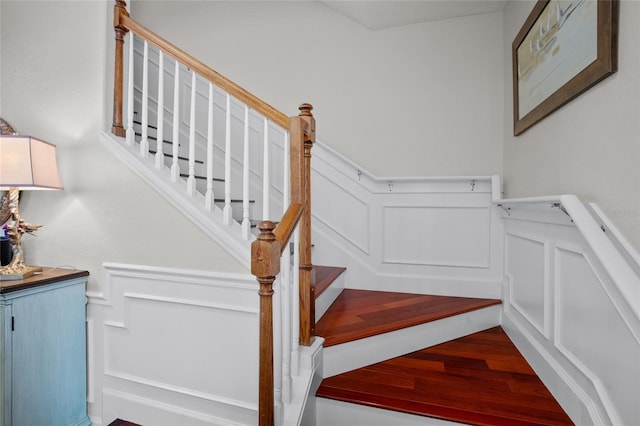 8401 Riverdale Ln Unit 8401, Davenport, FL 33896 - stairs with a decorative wall, wainscoting, and wood finished floors